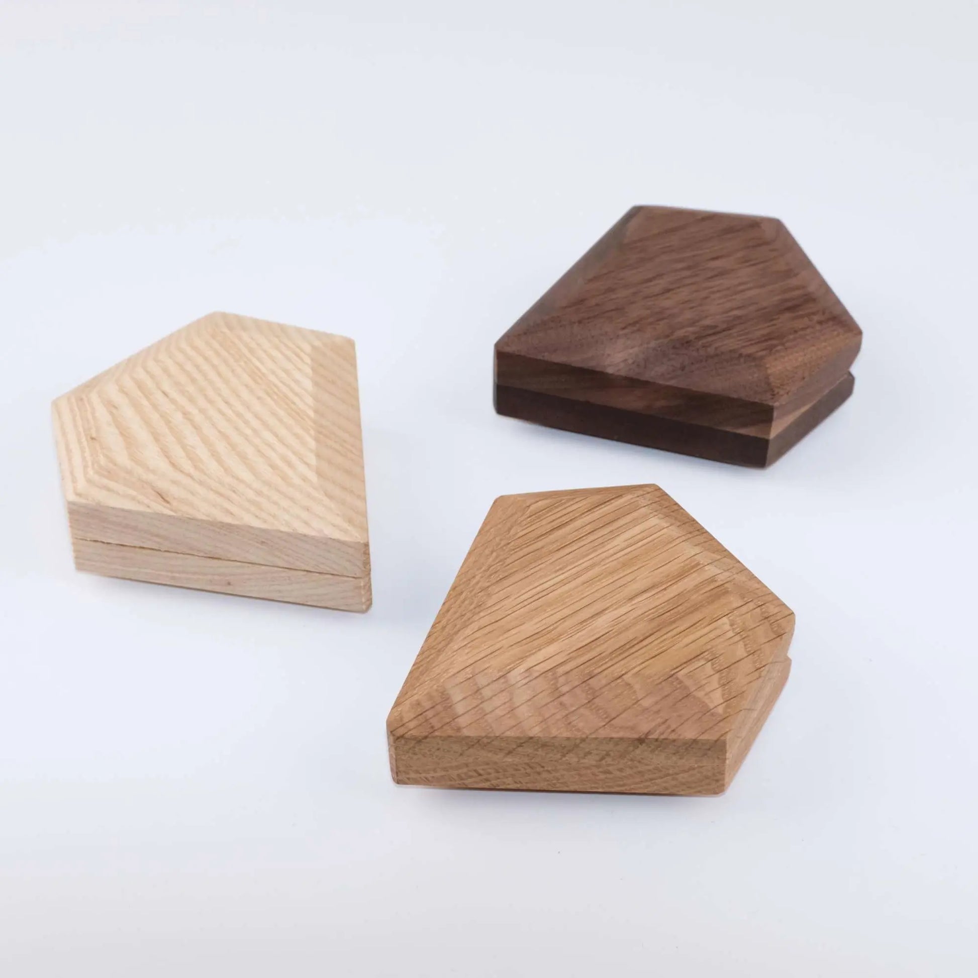 Black walnut, ash wood, and white oak diamond ring boxes closed - three premium wood finish options