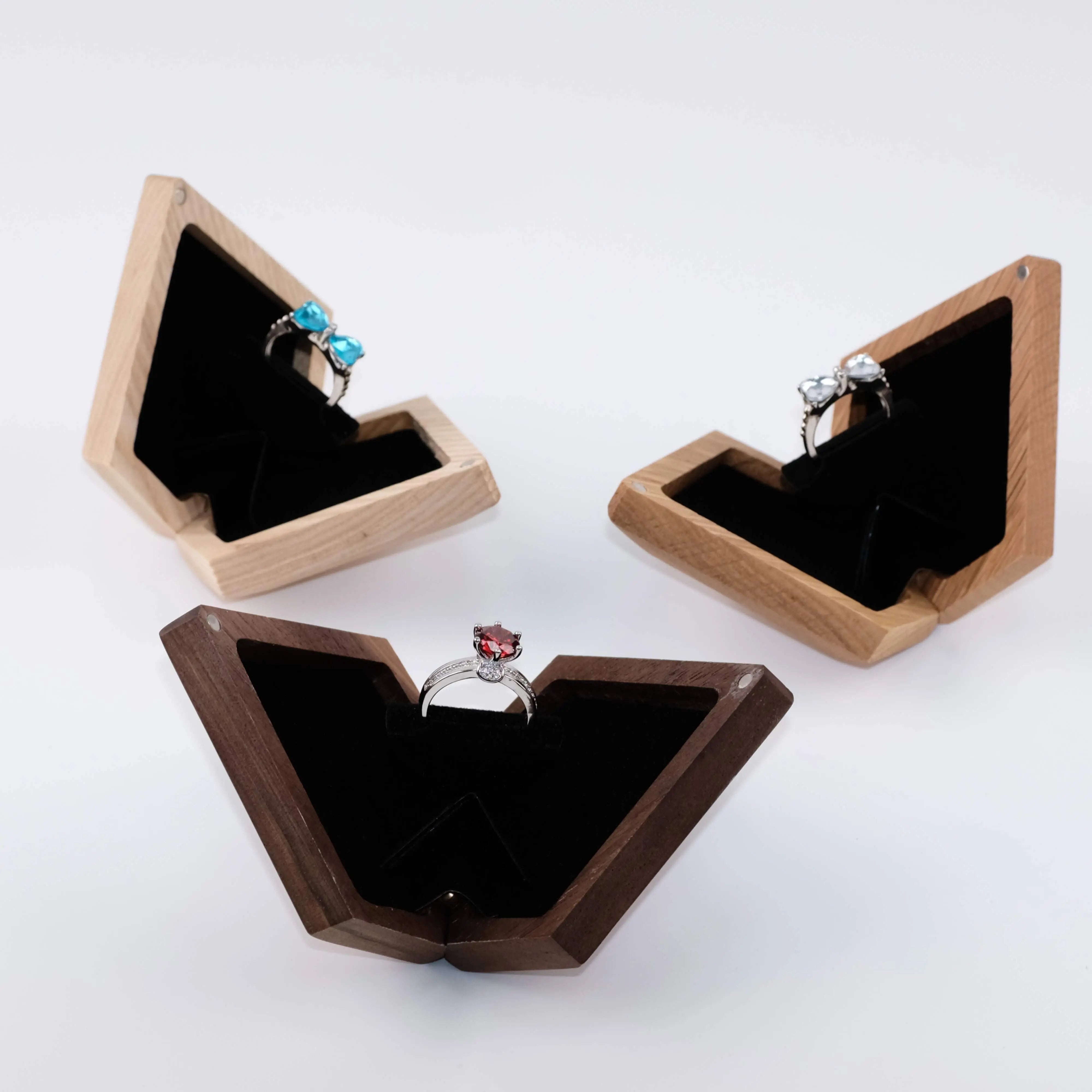 Black walnut, ash wood, and white oak diamond ring boxes open - three premium wood finishes with velvet ring holder