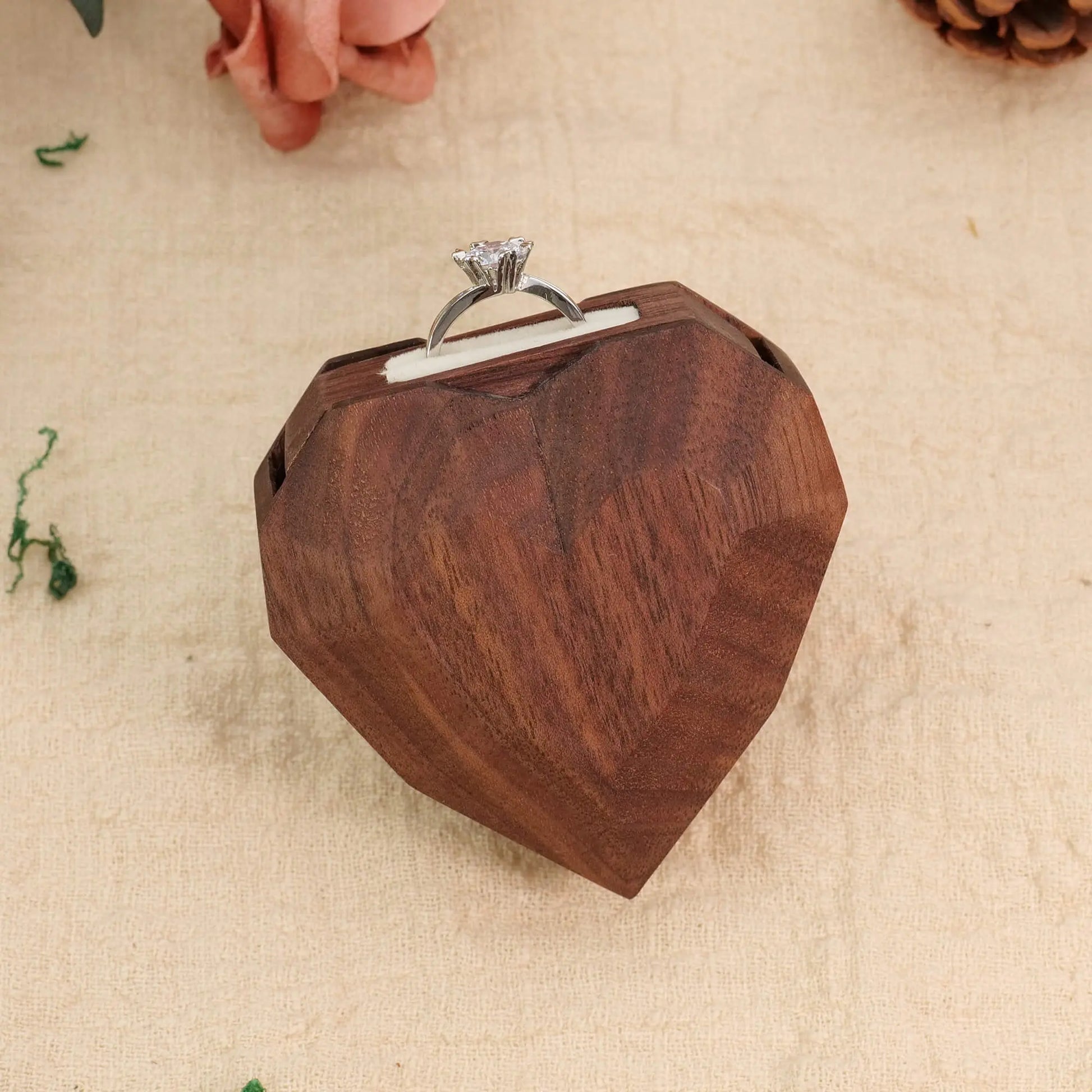 3D heart-shaped rotating ring box with ring flipped out - front view showing premium wood facets and ring presentation